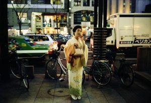 A Japanese woman in Kimono speaks on her cell phone on a street in Ginza, Tokyo.