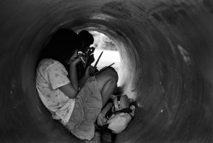 Girls make up in a concrete tube for construction in a park in Matsumoto, Nagao.