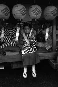 A small Japanese girl dressed in kimono in Yayoi Festival.
