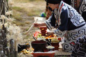 Ainu woman in a traditional ritual during the Chipusanke festival in Nibutani.