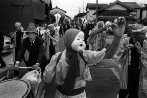 A man with the mask of Otafuku in a fall festival in Hikawa, Shimane.