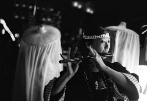 A Japanese woman plays the Japanese flute during Kanto Festival.