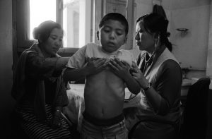 An exiled Tibetan family in a Tibetan clinic in Dharamsala, India.