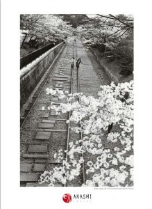 Girls walk over an old railway in Kyoto