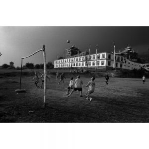 Exiled Tibetan Monks play soccer behind their monastery. Bir, India