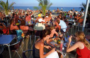 Tourists at the bar on the Barceloneta beach in Barcelona, Spain.