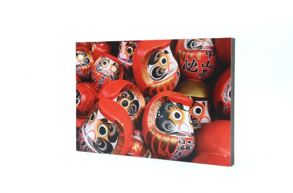Daruma with both eyes painting ready to be burnt.