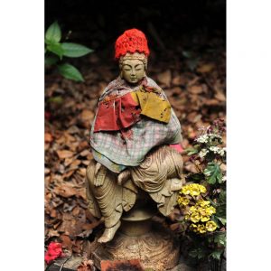Jizo, protector of women, children, and travelers, sits on the path on the way to a temple on the route of Shikoku Henro.